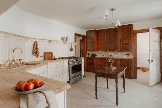 A rustic kitchen with wooden cabinets and a stove.
